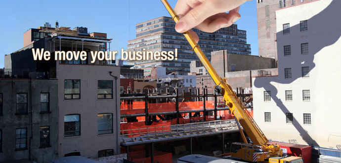 A human hand is moving the beam of a mobile crane.